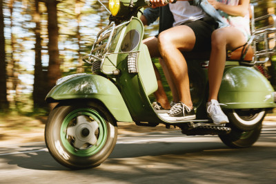 couple-riding-a-green-scooter-on-a-sunny-day-2026-03-26-01-42-01-utc.jpg
